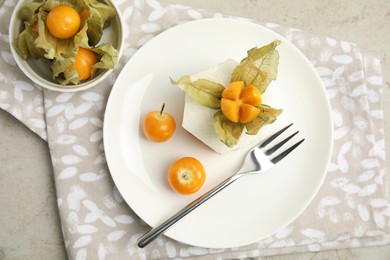 Photo of Delicious dessert decorated with physalis on grey table, flat lay