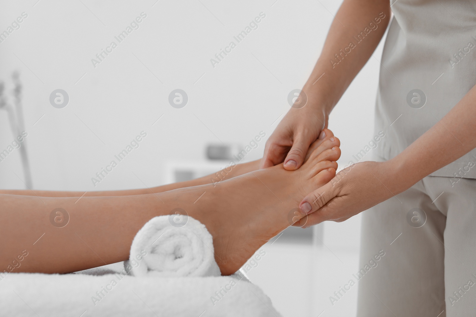 Photo of Woman receiving foot massage in wellness center, closeup