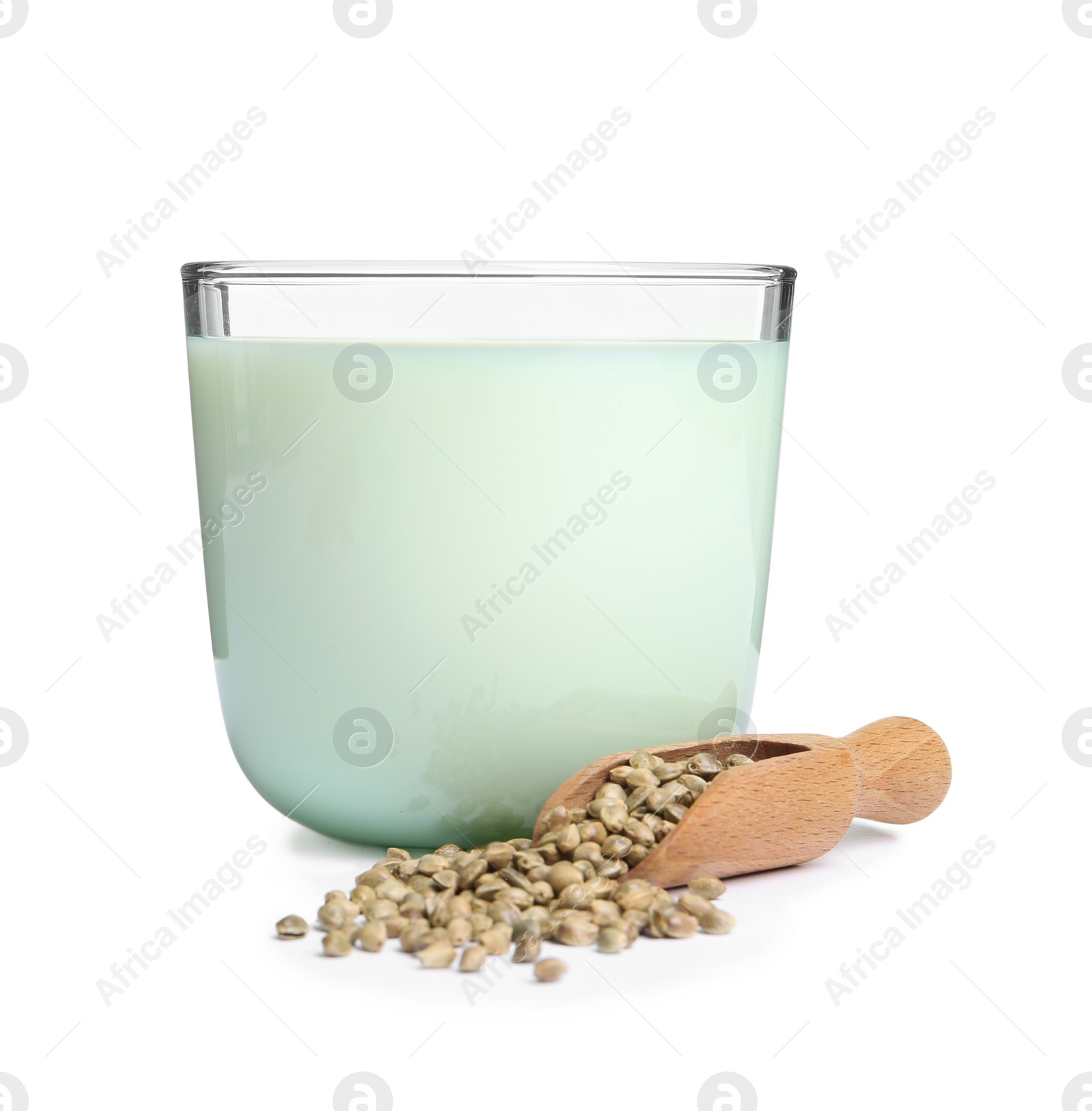 Photo of Scoop with hemp seeds and glass of milk on white background