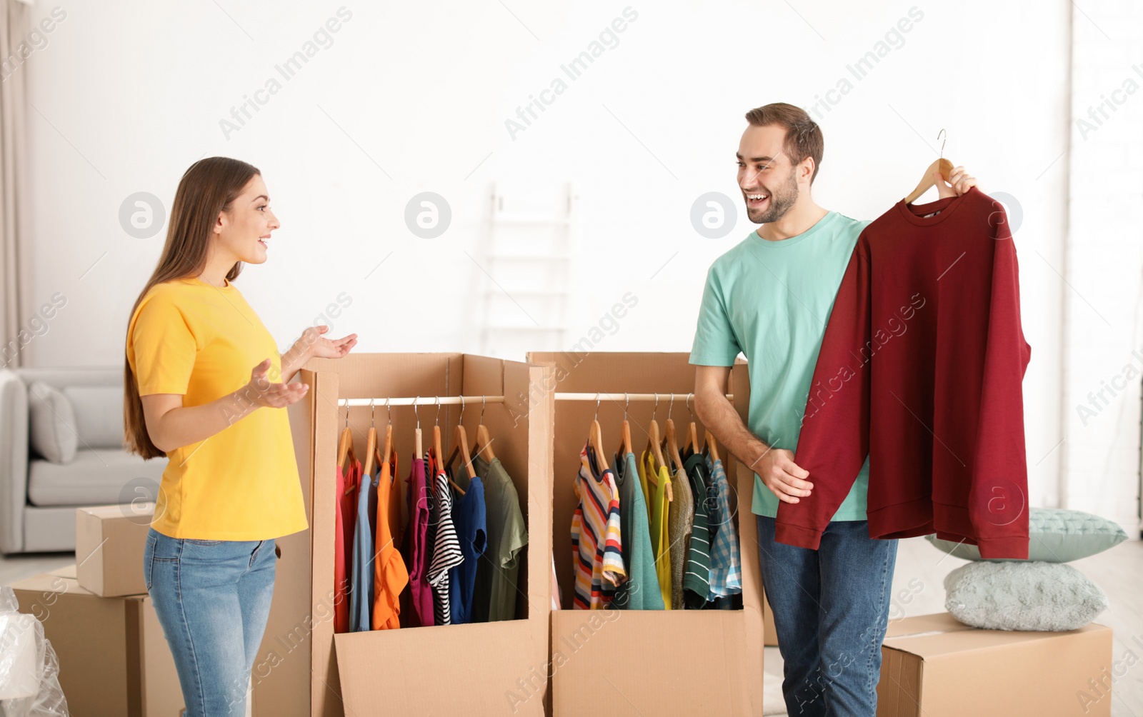 Photo of Young couple near wardrobe boxes at home