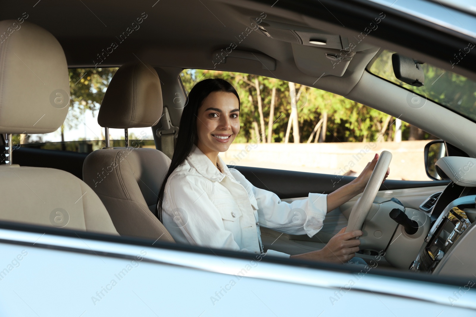 Photo of Beautiful young driver sitting in modern car