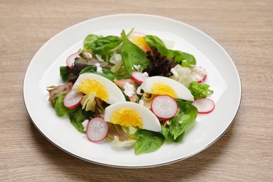 Photo of Delicious salad with boiled egg, radish and cheese on wooden table, closeup