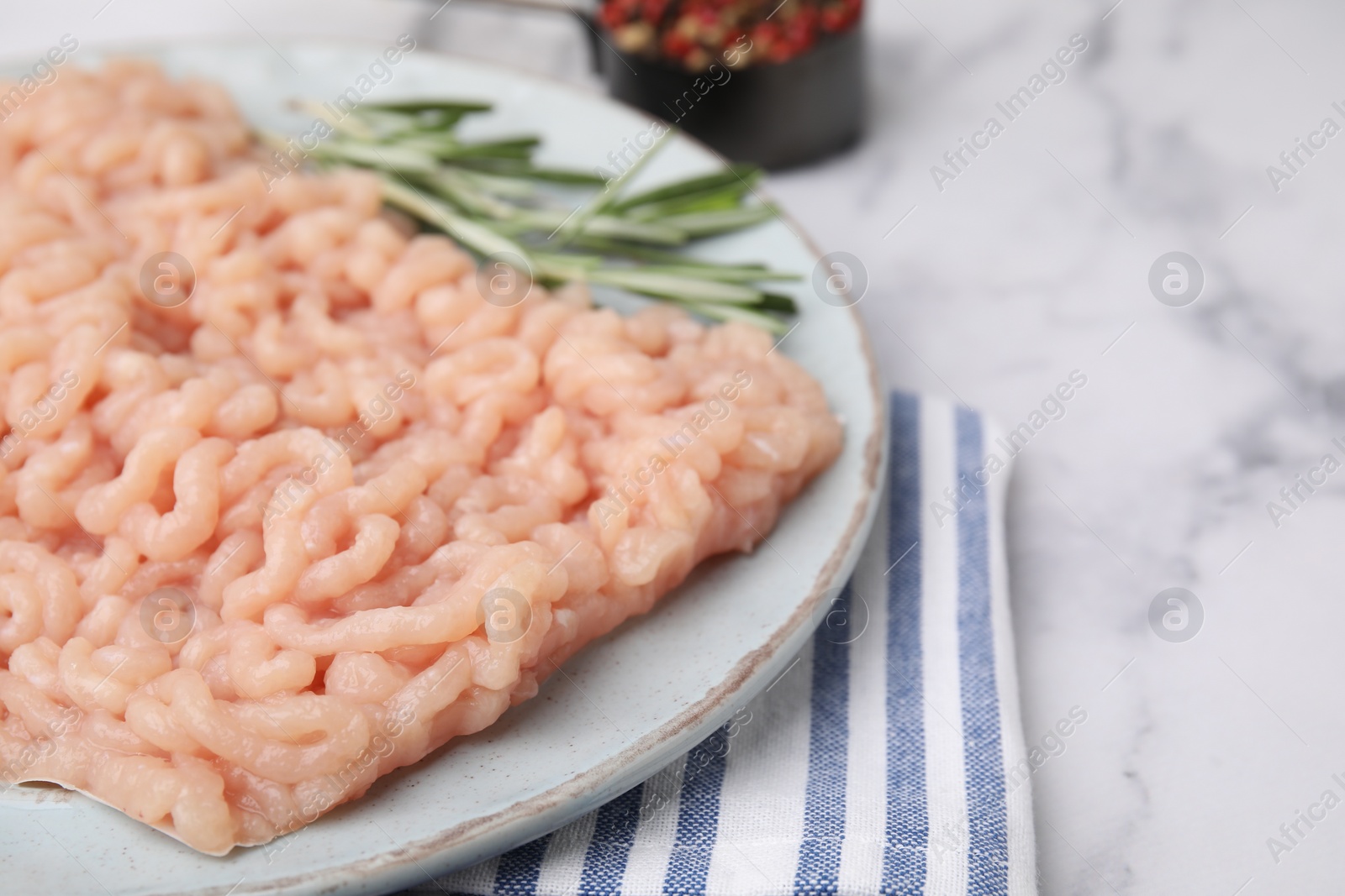Photo of Fresh raw minced meat on white marble table, closeup. Space for text