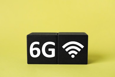 Photo of Cubes with 6G and WiFi symbols on yellow background