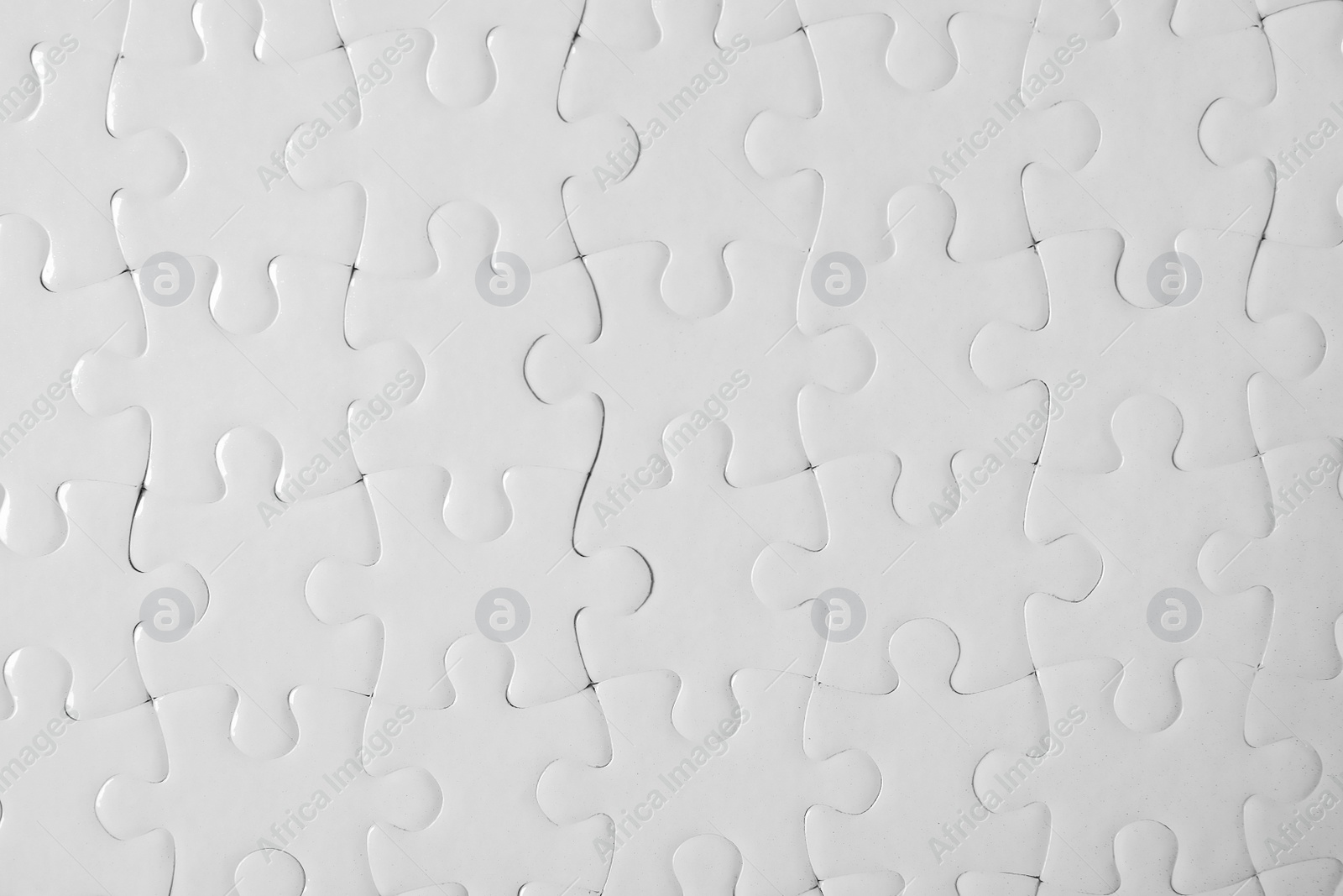 Photo of Blank white puzzle as background, top view