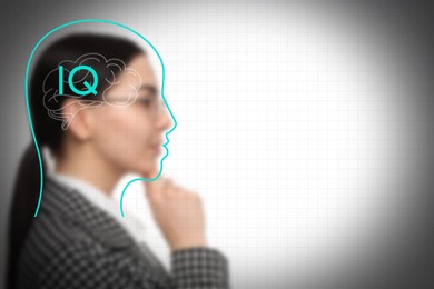 Image of Illustrated head with brain and blurred view of woman on light background. IQ test