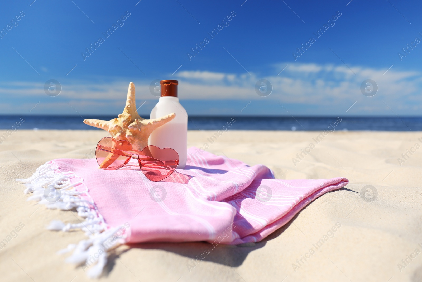 Photo of Stylish beach accessories for summer vacation on sand near sea