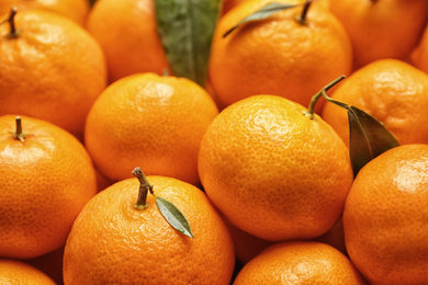 Photo of Delicious fresh ripe tangerines as background, closeup