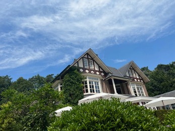 Photo of Picturesque view of beautiful house and plants on sunny day