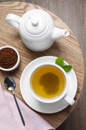 Photo of Buckwheat tea served on wooden table, flat lay