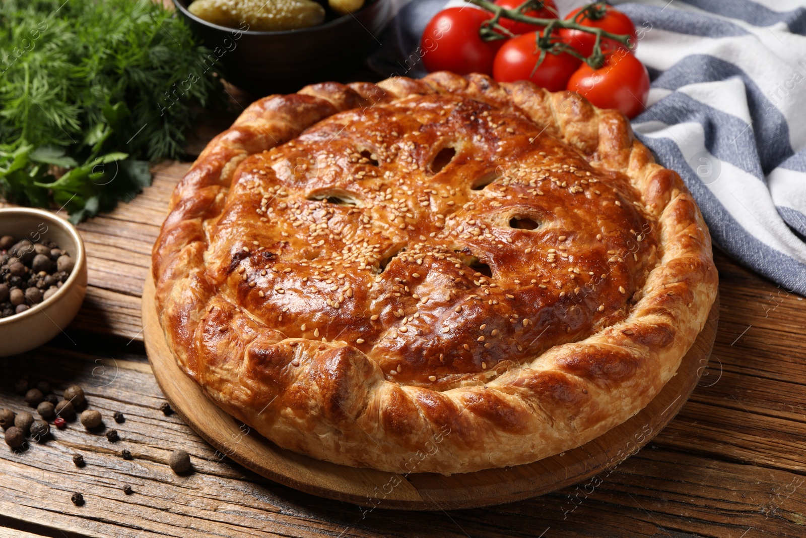 Photo of Tasty homemade pie and ingredients on wooden table