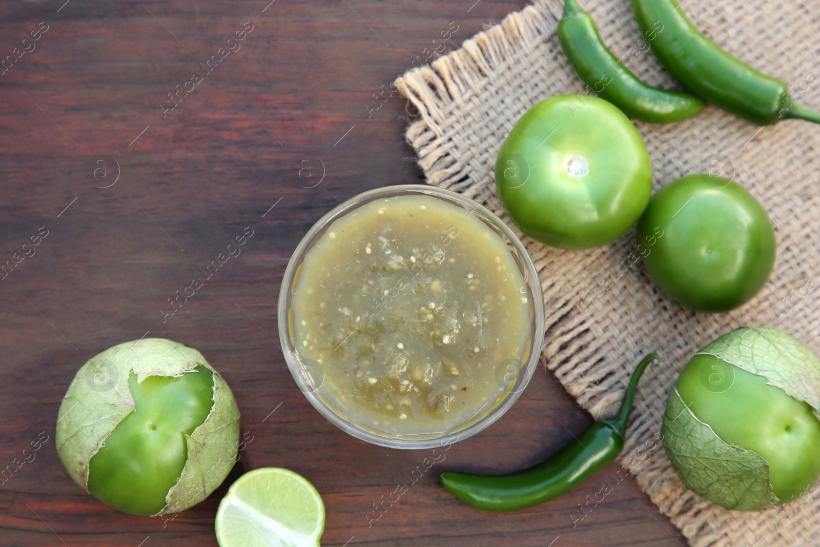 Photo of Tasty salsa sauce and ingredients on wooden table, flat lay