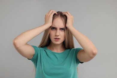 Photo of Portrait of resentful woman on grey background