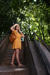 Photo of Travel blogger recording video outdoors, low angle view