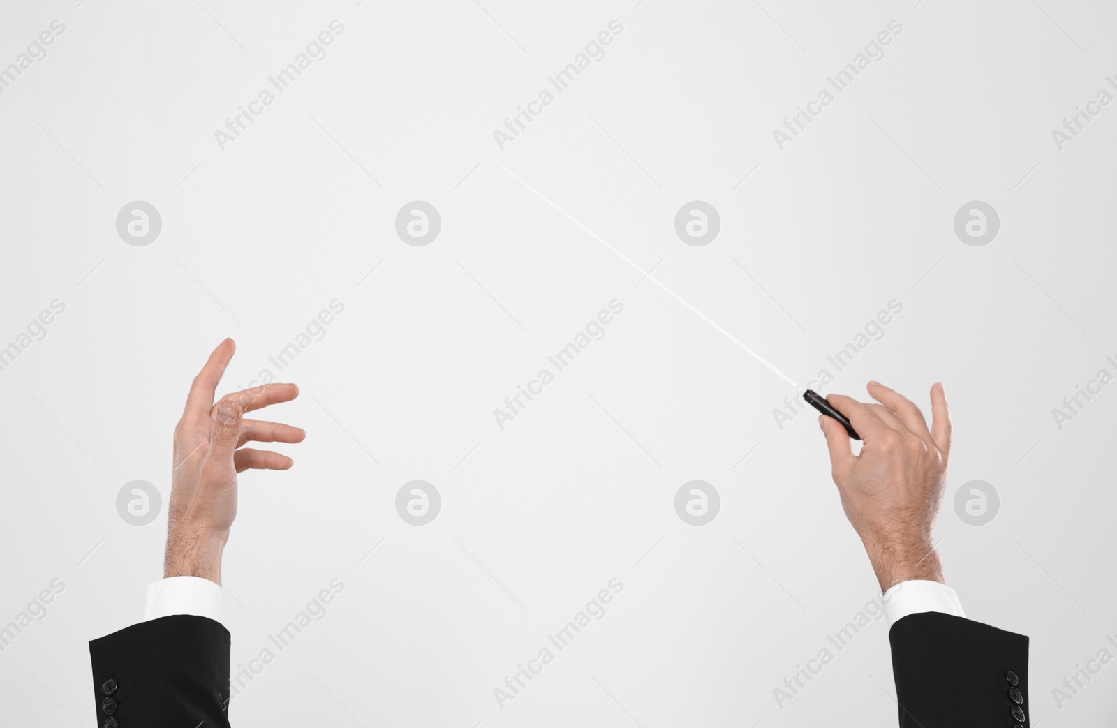 Photo of Professional conductor with baton on white background, closeup