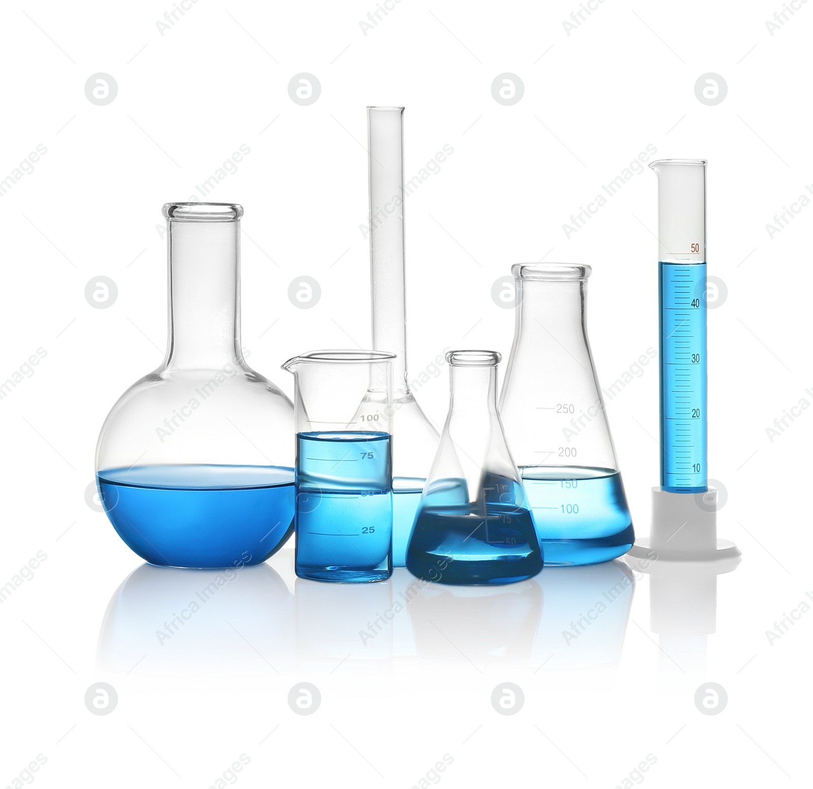 Photo of Different laboratory glassware with light blue liquid isolated on white