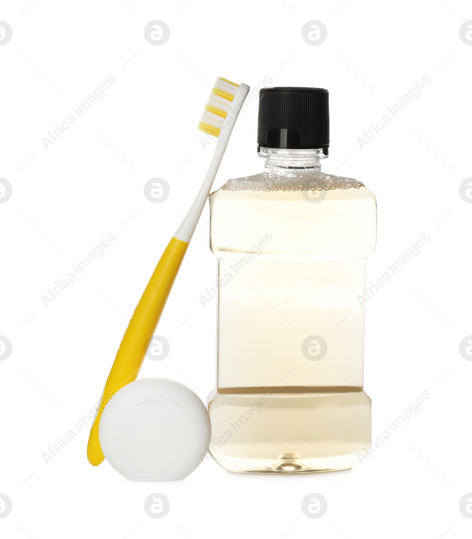 Photo of Bottle with mouthwash, dental floss and toothbrush on white background