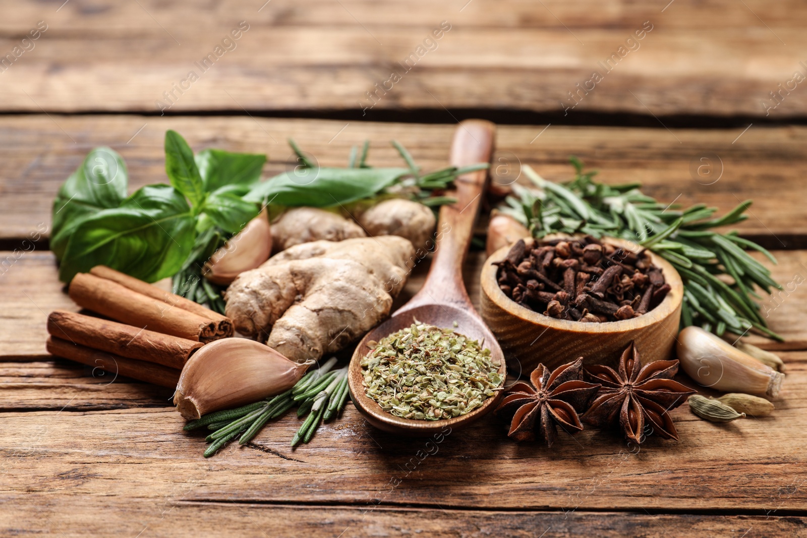 Photo of Different natural spices and herbs on wooden table