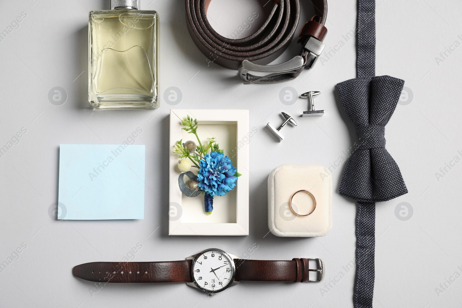 Photo of Wedding stuff. Flat lay composition with stylish boutonniere on light gray background