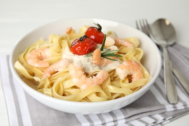 Delicious pasta with shrimps served on table