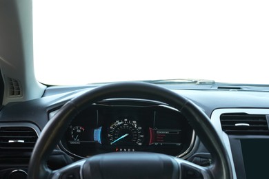 Speedometer on dashboard and steering wheel inside car
