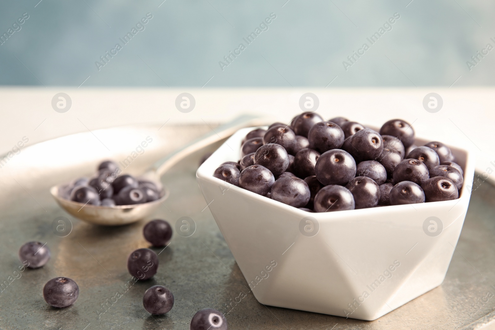 Photo of Bowl with fresh acai berries on tray, closeup