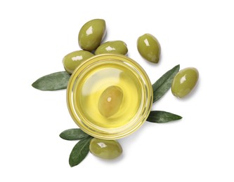 Photo of Cooking oil in bowl, olives and leaves on white background, top view