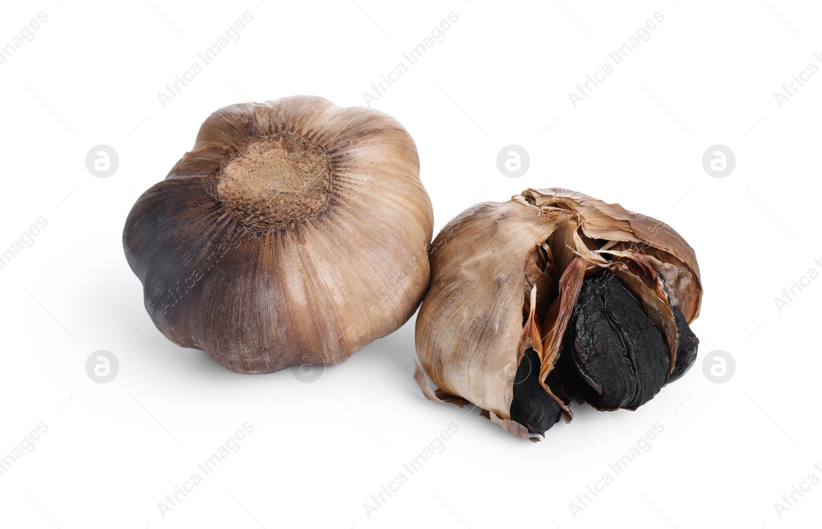 Photo of Bulbs of fermented black garlic isolated on white