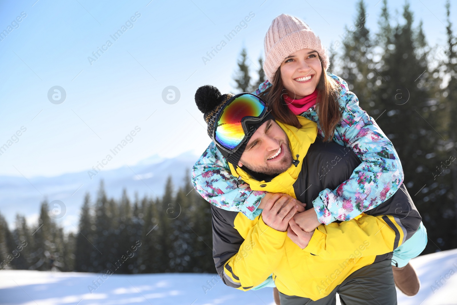 Photo of Happy young couple outdoors, space for text. Winter vacation