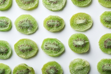 Photo of Slices of kiwi on white background, flat lay. Dried fruit as healthy food