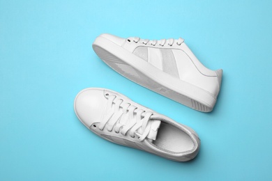 Photo of Flat lay composition of stylish shoes on color background