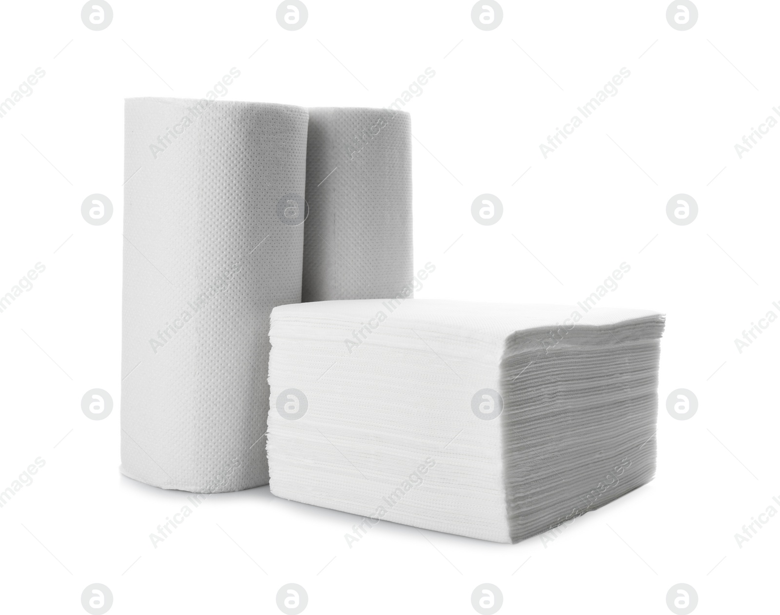 Photo of Rolls and stack of clean paper tissues on white background