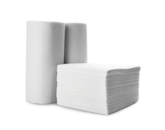 Photo of Rolls and stack of clean paper tissues on white background