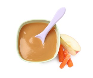 Photo of Tasty baby food in bowl, spoon, cut apple and carrots isolated on white, top view