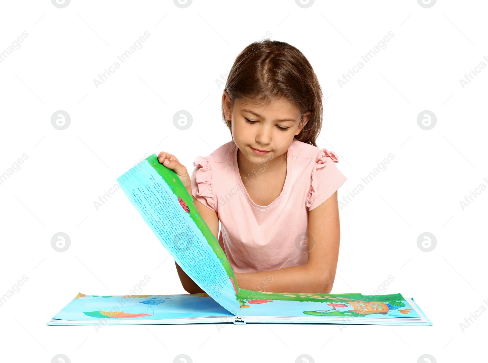 Photo of Cute little girl reading book on white background