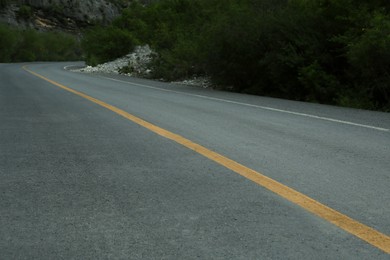 Photo of Beautiful view of empty asphalt highway near mountains outdoors. Road trip