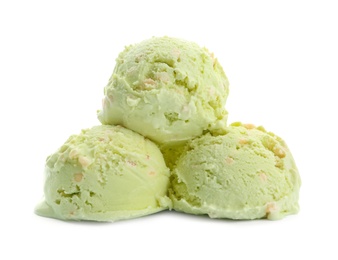 Scoops of delicious pistachio ice cream on white background