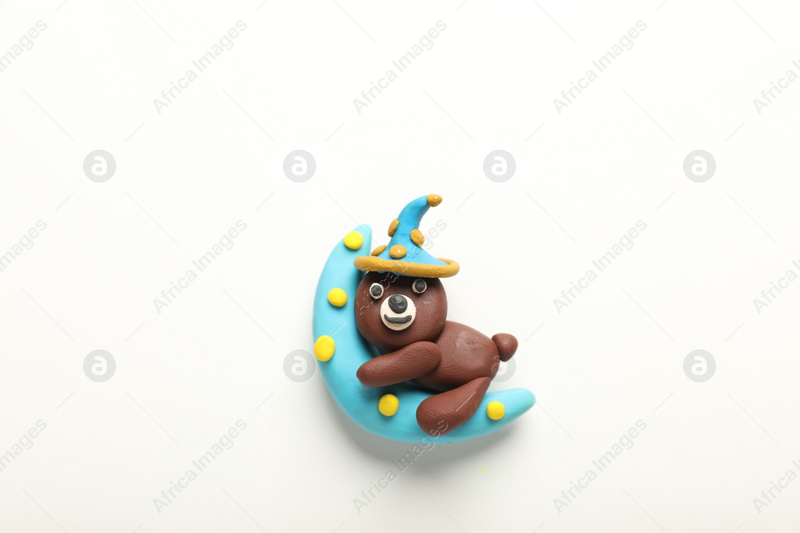 Photo of Beautiful bear and moon made of plasticine on white background, top view