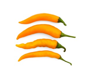 Photo of Fresh raw hot chili peppers on white background, flat lay