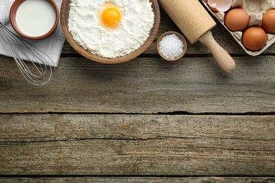 Photo of Many different cooking ingredients on wooden table, flat lay. Space for text