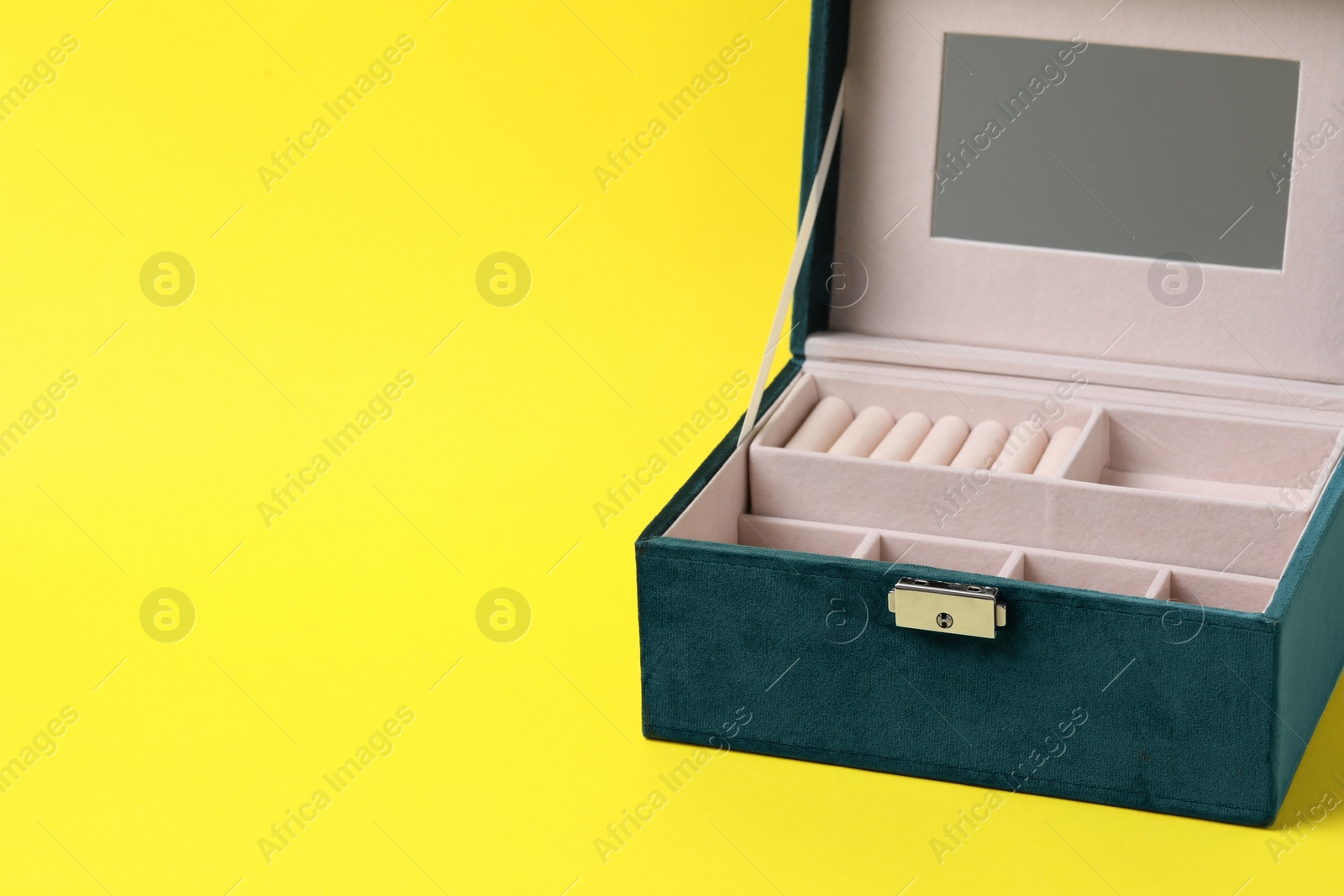 Photo of One empty jewelry box on yellow background, space for text
