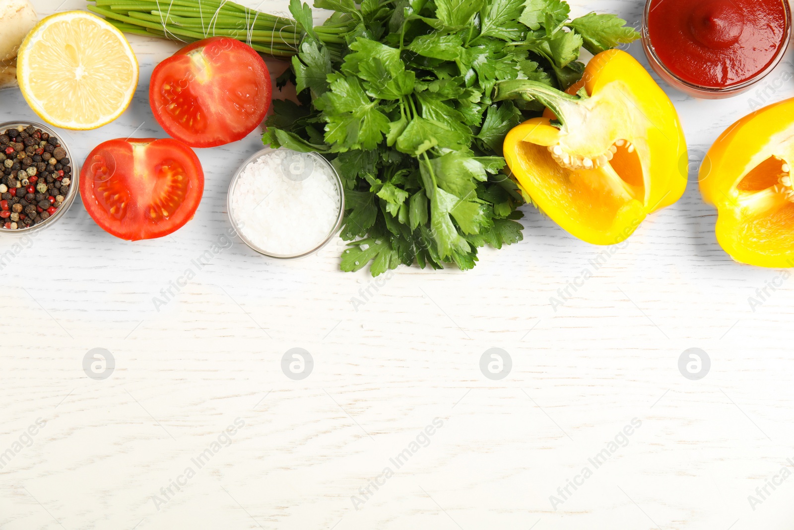 Photo of Flat lay composition with ingredients for cooking on white wooden table. Space for text