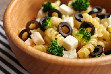 Wooden bowl with delicious pasta primavera, closeup