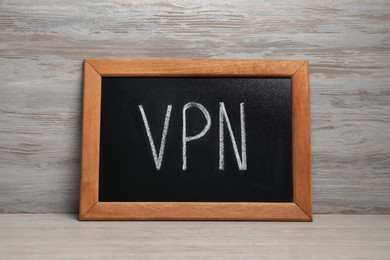 Photo of Chalkboard with acronym VPN on wooden table