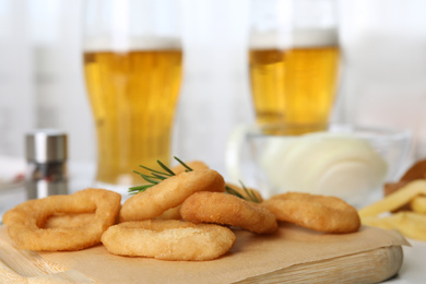 Photo of Fried onion rings served on table, closeup