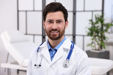 Photo of Portrait of medical consultant with stethoscope in clinic