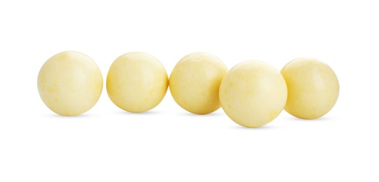 Photo of Bright yellow chewy gumballs isolated on white