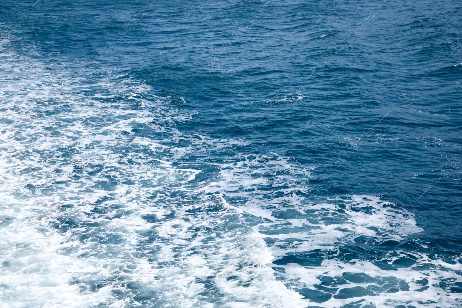 Photo of Surface of beautiful sea water with foam as background