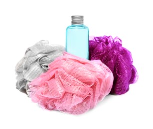 Photo of New shower puffs and bottle of cosmetic product on white background