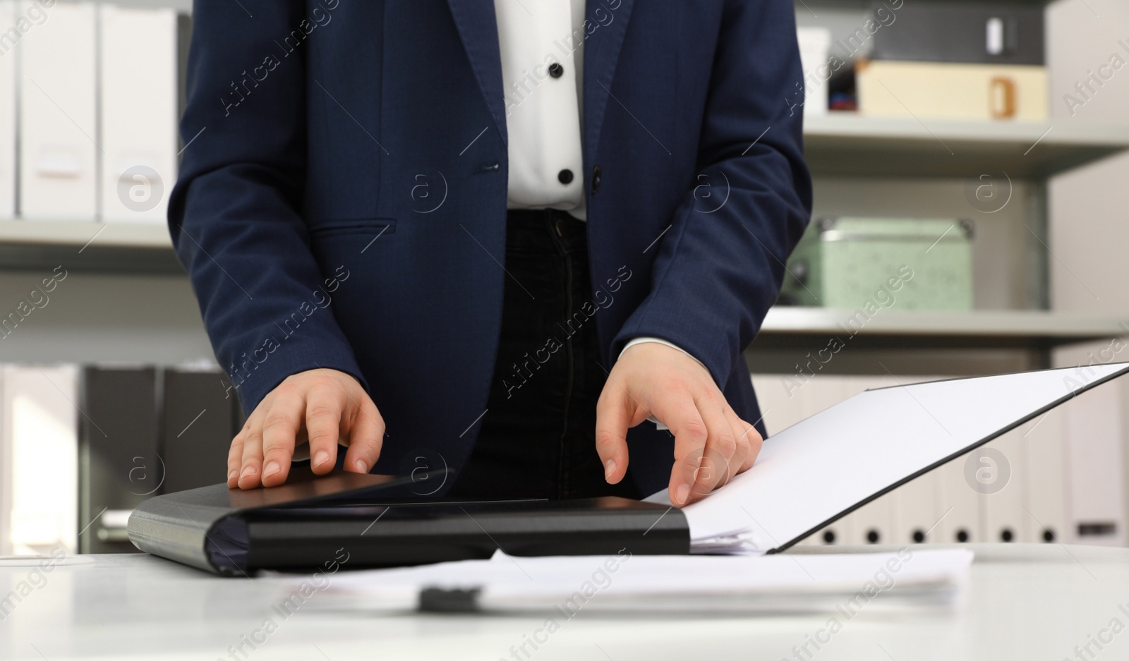 Photo of Woman working with documents at table in office, closeup